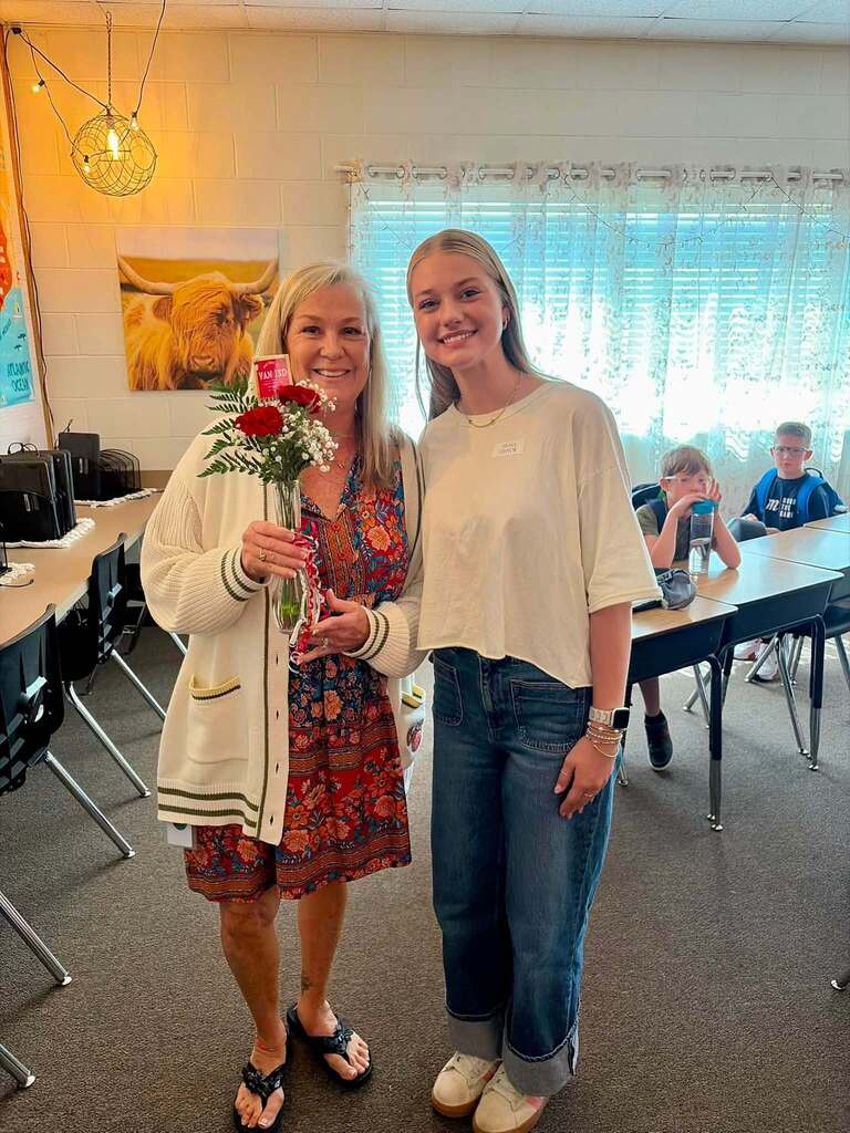 teacher receiving flowers from student
