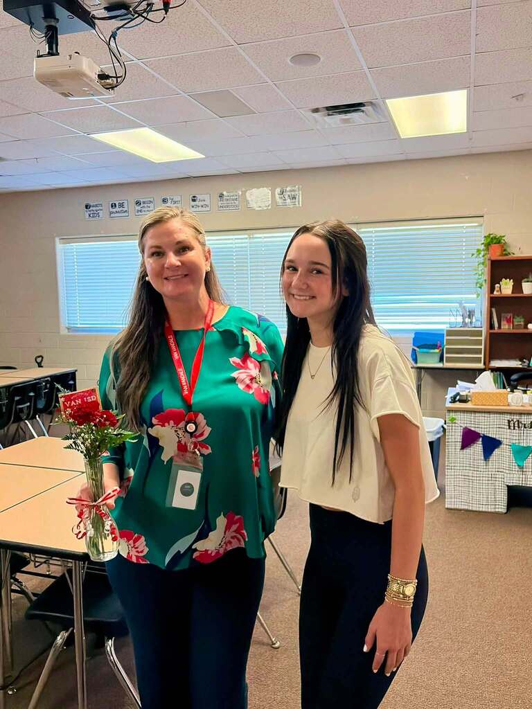 teacher receiving flowers from student
