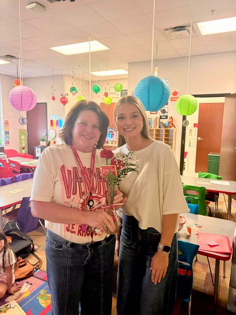 teacher receiving flowers from student