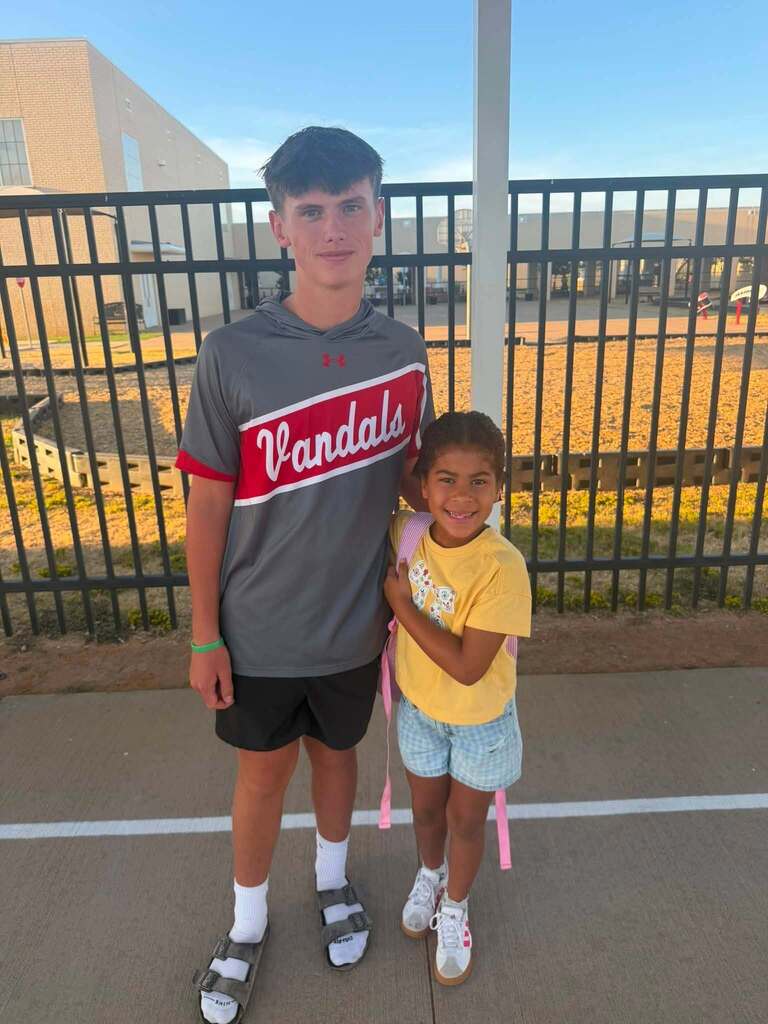 High school boy with elementary girl