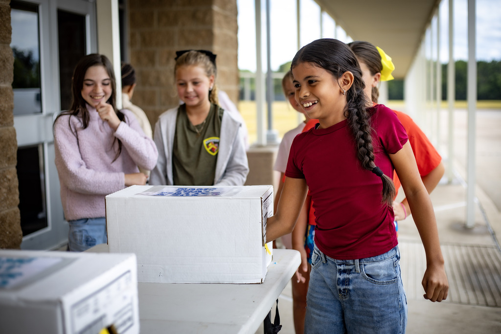 GIRL WITH HER HAND IN A BOX