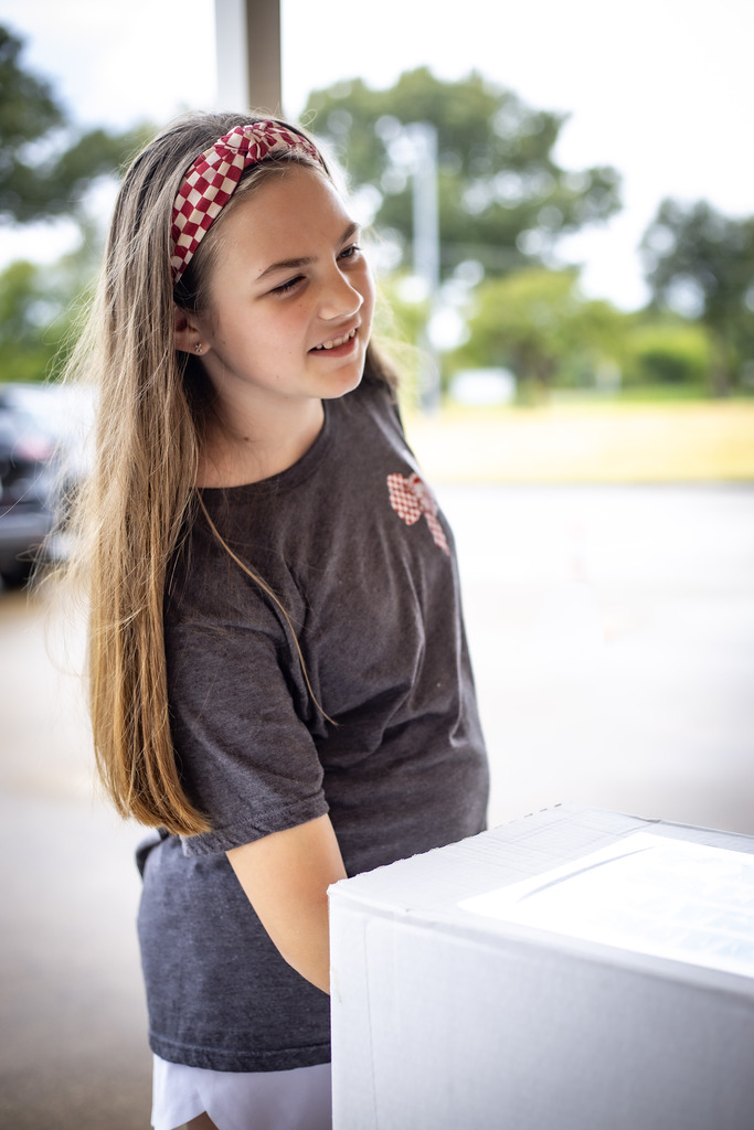 GIRL WITH HER HAND IN A BOX