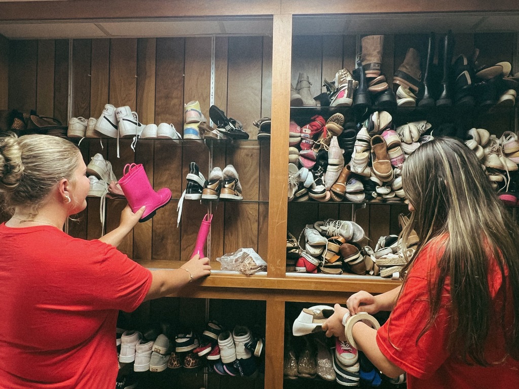 students serving in a clothing closet