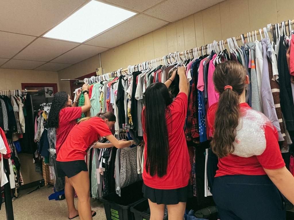 students serving in a clothing closet