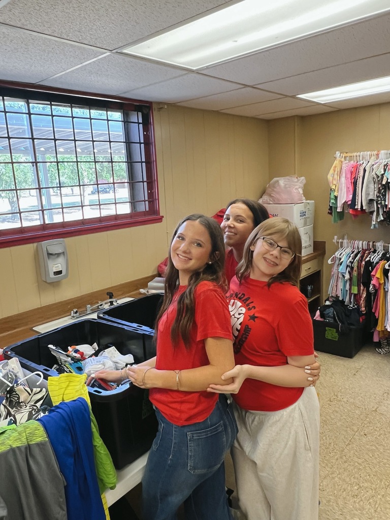 students serving in a clothing closet
