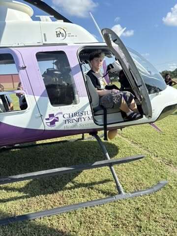student in a helicopter 