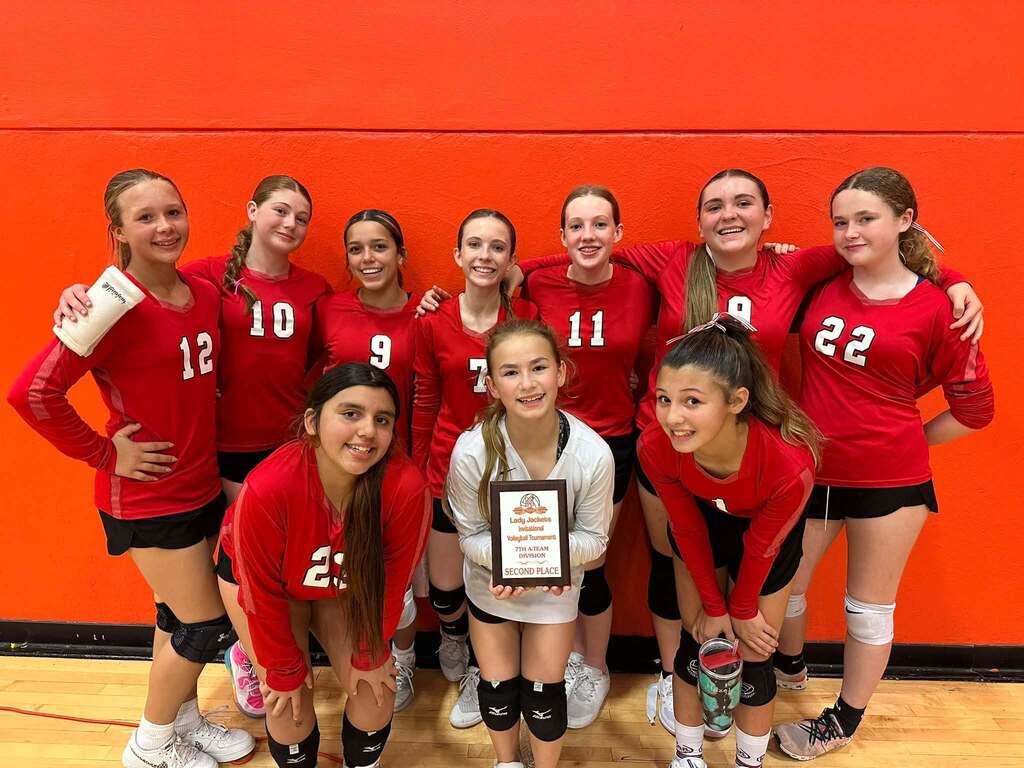 volleyball team holding a plaque