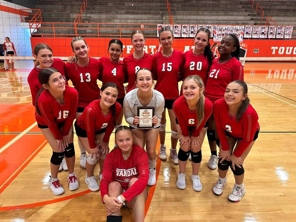 volleyball team holding a plaque