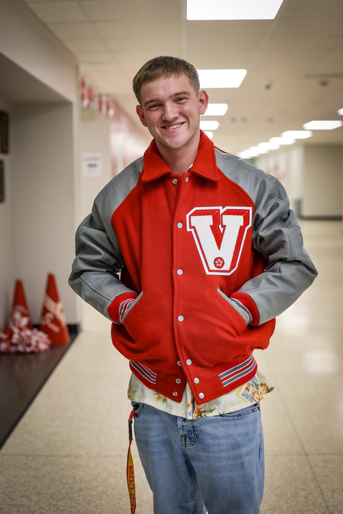 High school student wearing his new letter jacket