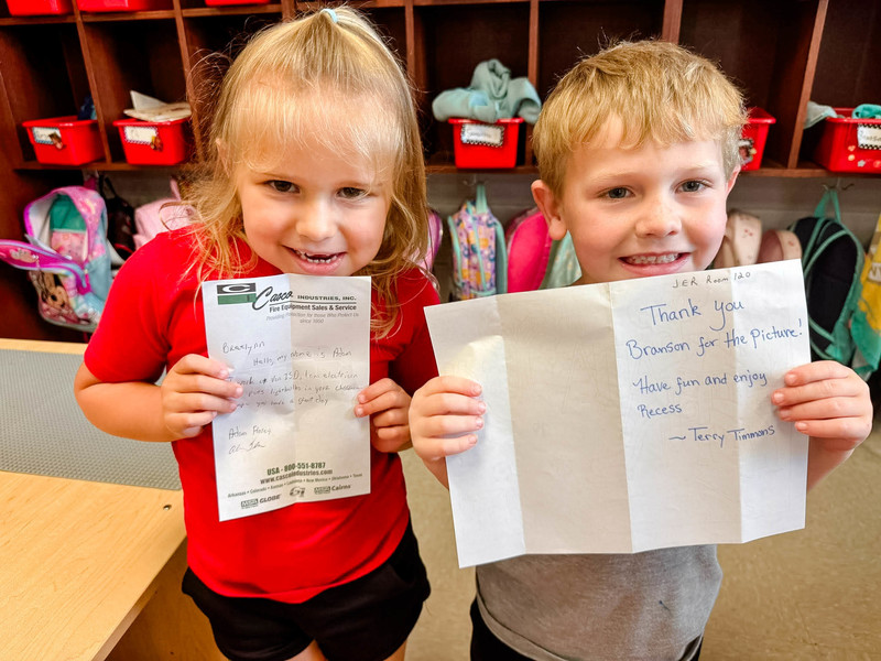 students holding up their mail
