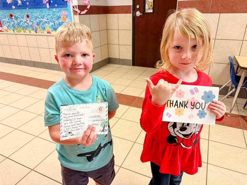 students holding up their mail