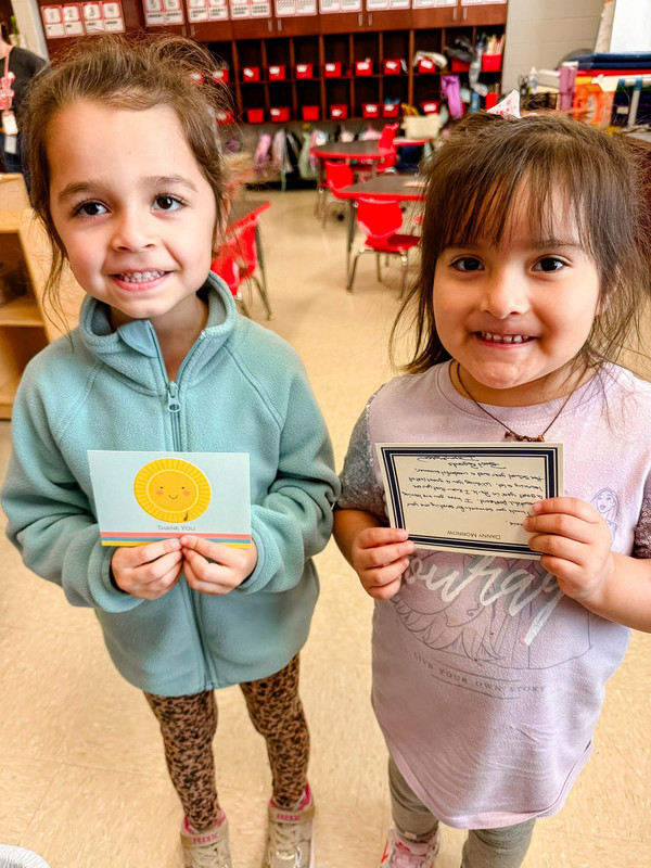 students holding up their mail