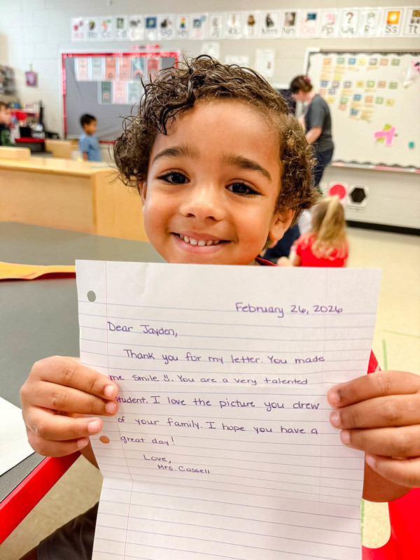 students holding up their mail