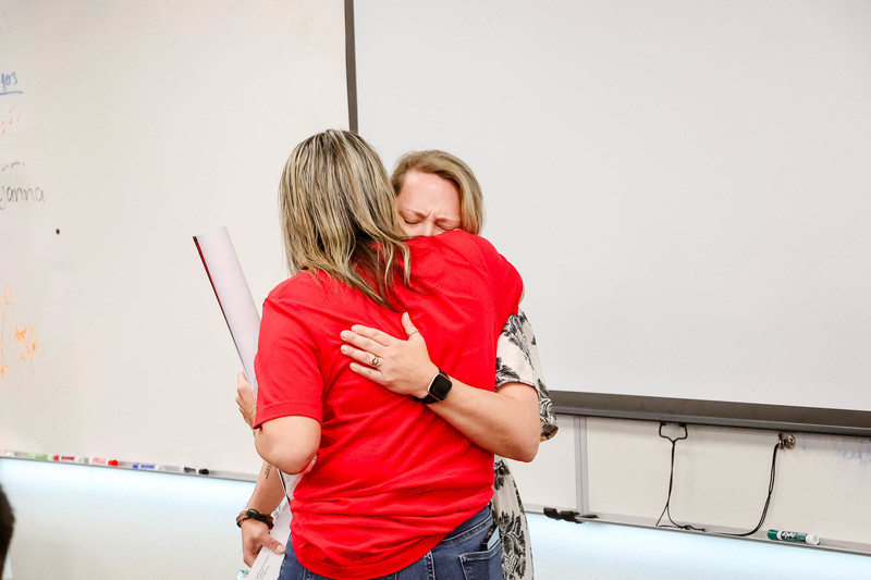 Mrs. Rolison wins Teacher of the Year and hugs a colleague