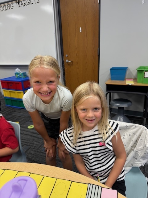 Kindergarten and 3rd grade buddies smiling