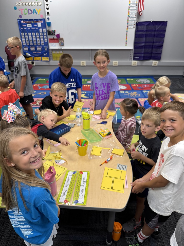 Kindergarten and 3rd grade buddies smiling