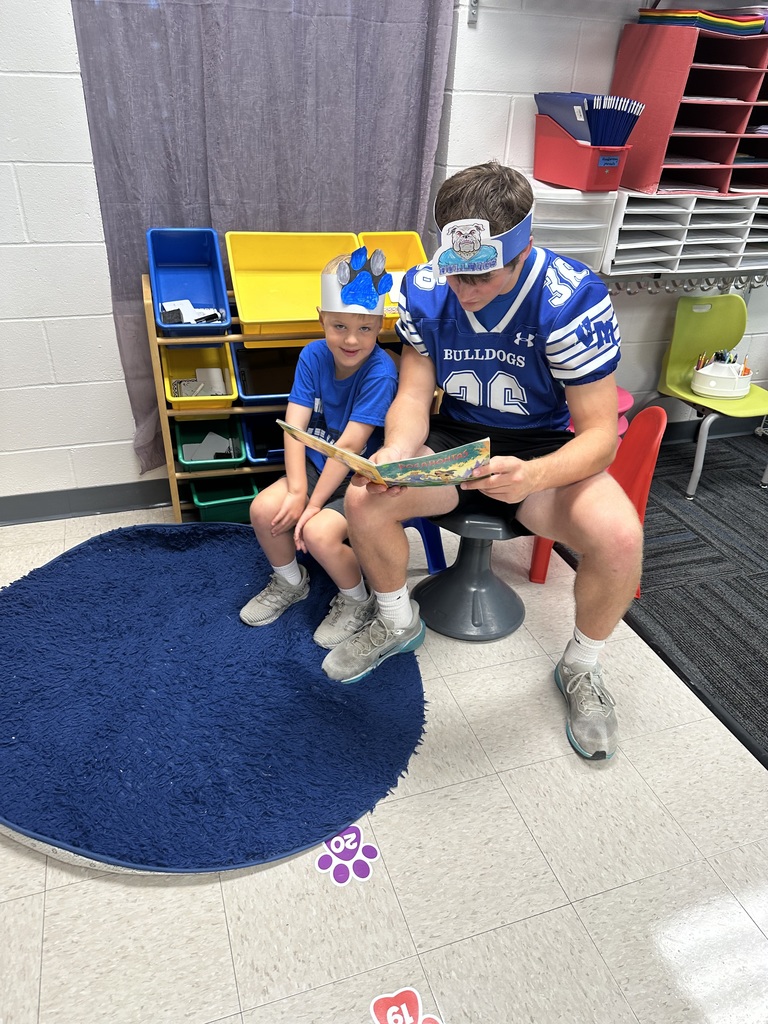 Older buddy reading with younger buddy.
