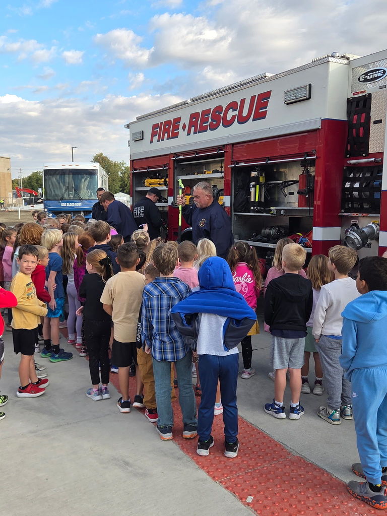 Students getting an up-close look at the fire truck and the items it holds.