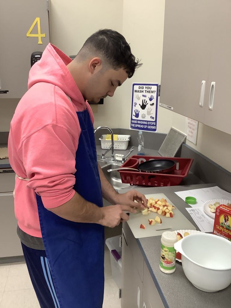 A student cutting apples.