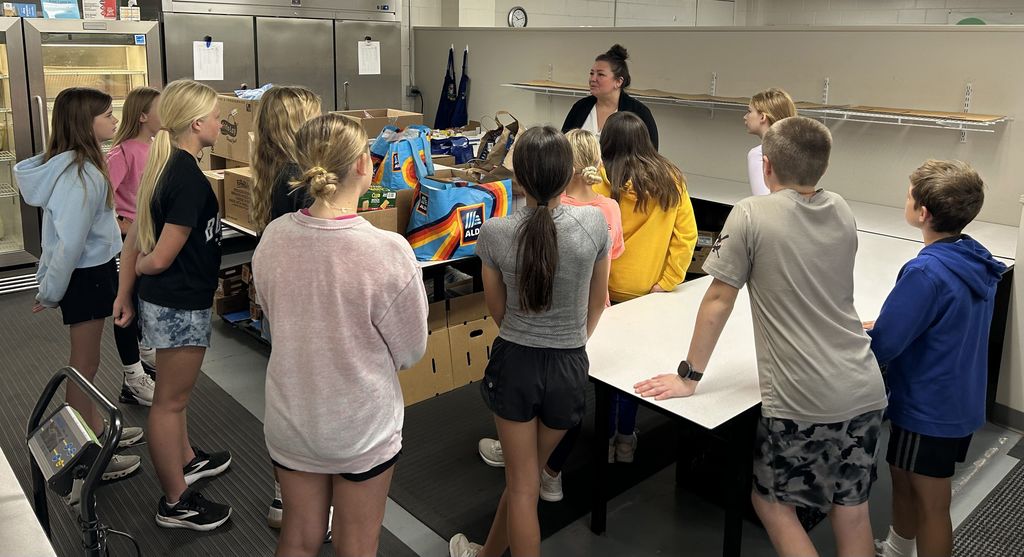 Students gathering the items in the room.