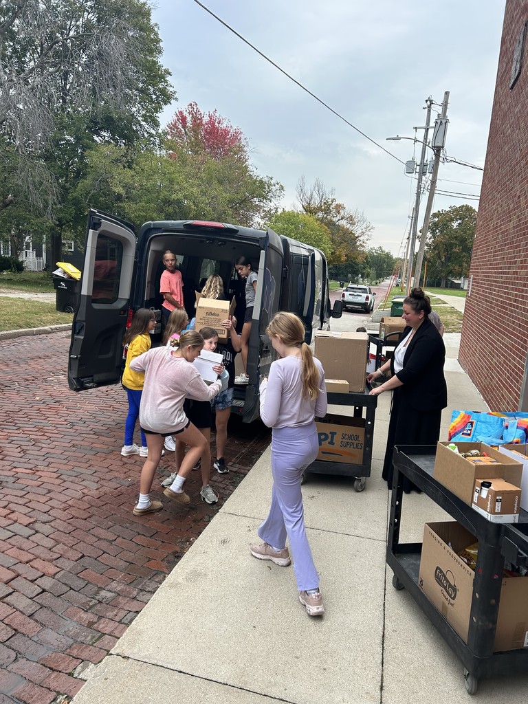 Students loading the van with items.