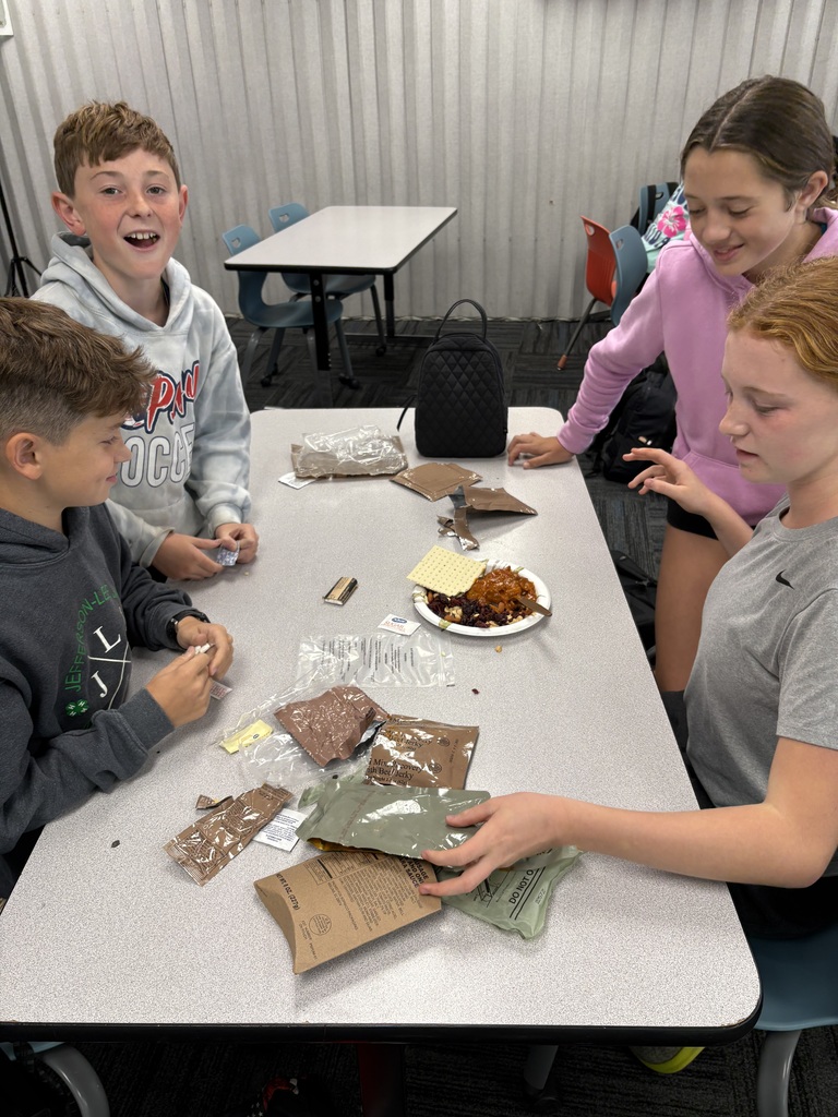Four students examining the food