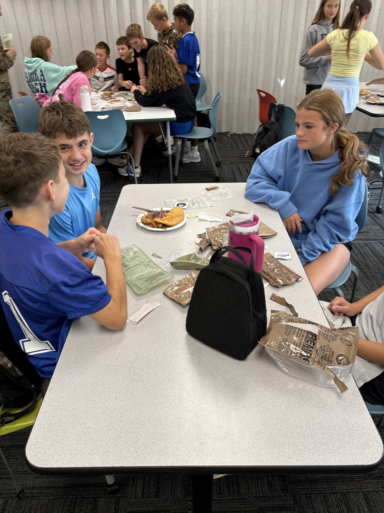 Students at a table talking about the food experience