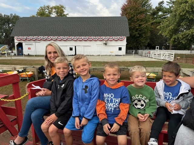 Five students a and chaperone posed for a picture on a bench