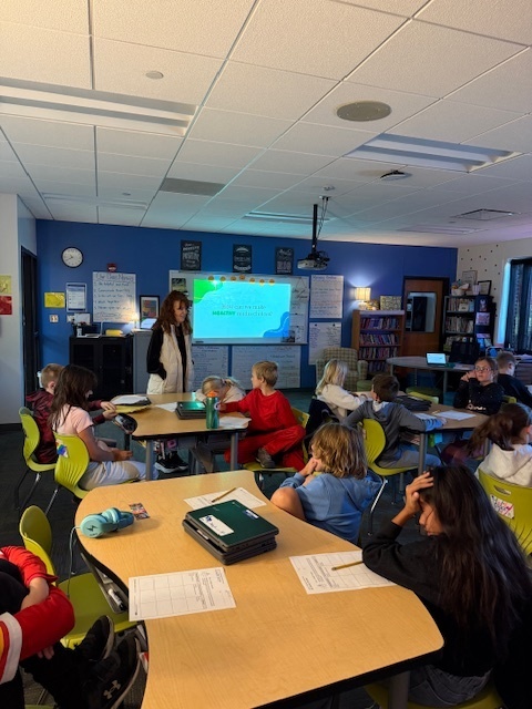 Students listening to the speaker talk.