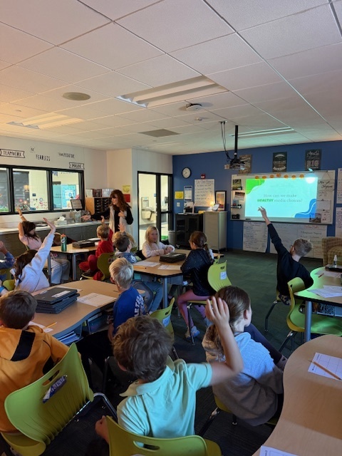 Students raising their hands to ask questions.