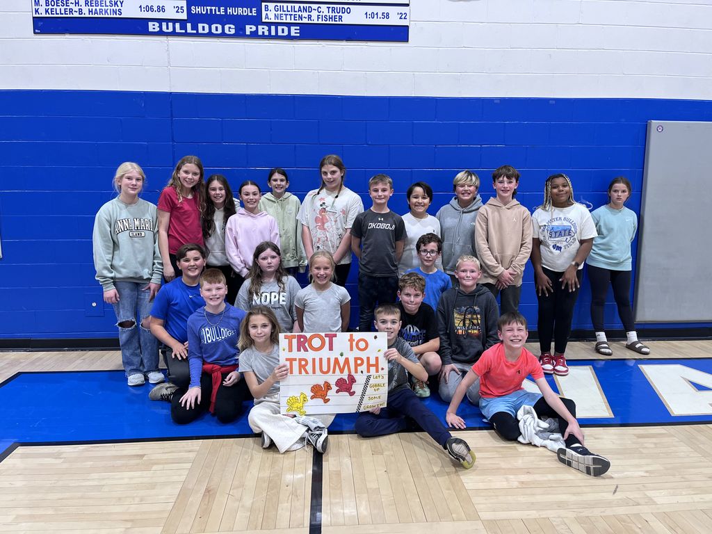 A class of our 5th graders posed for a picture withe the Trot to Triumph sign.
