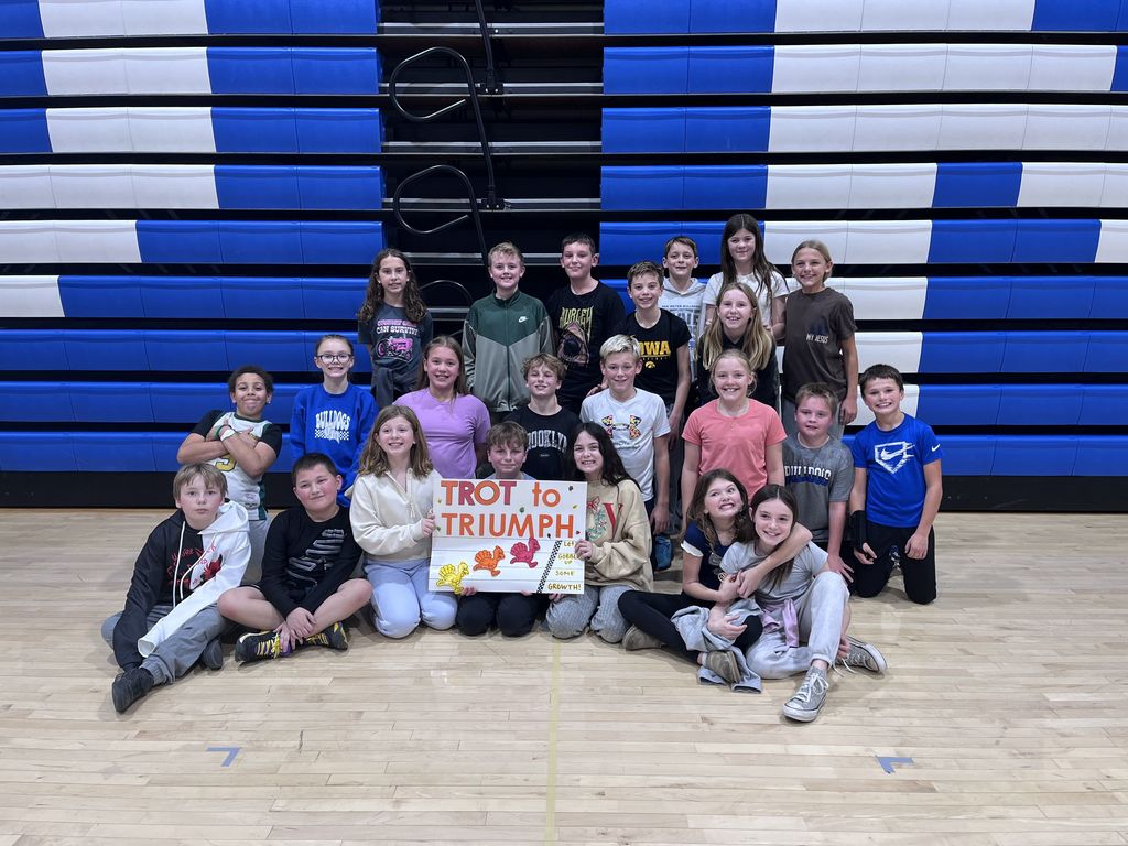 A class of our 5th graders posed for a picture withe the Trot to Triumph sign.