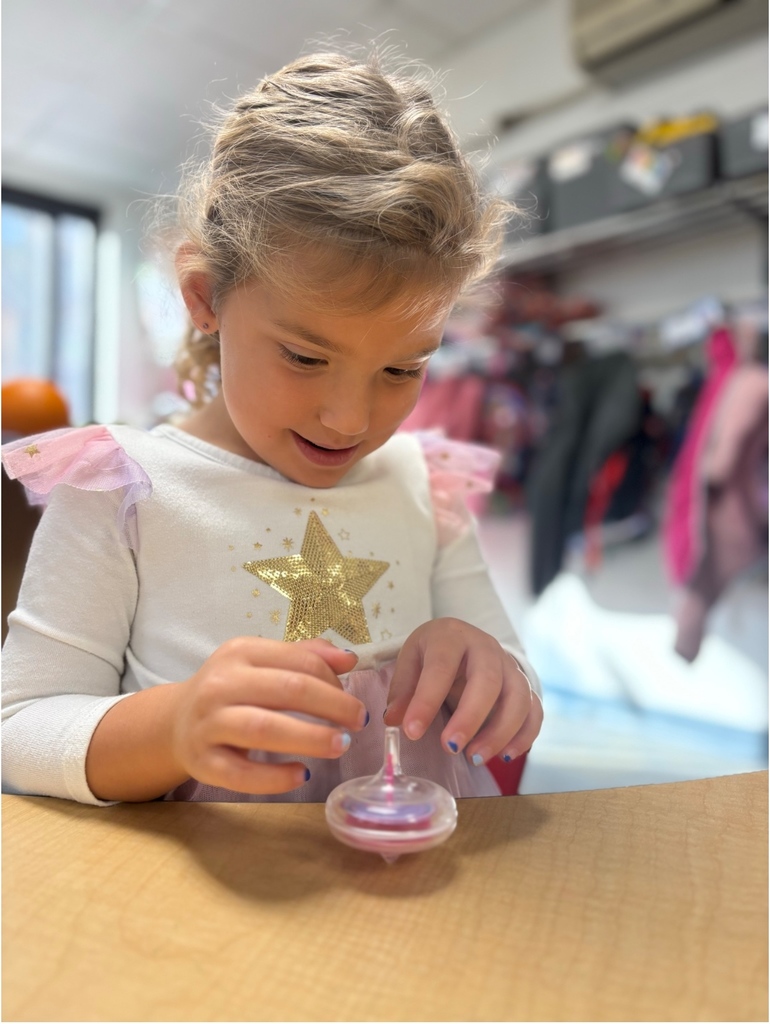 A student playing with a spin toy.