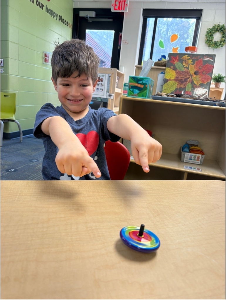 A student playing with a spin toy.