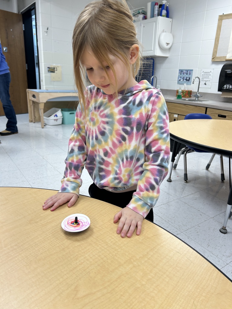 A student playing with a spin toy.