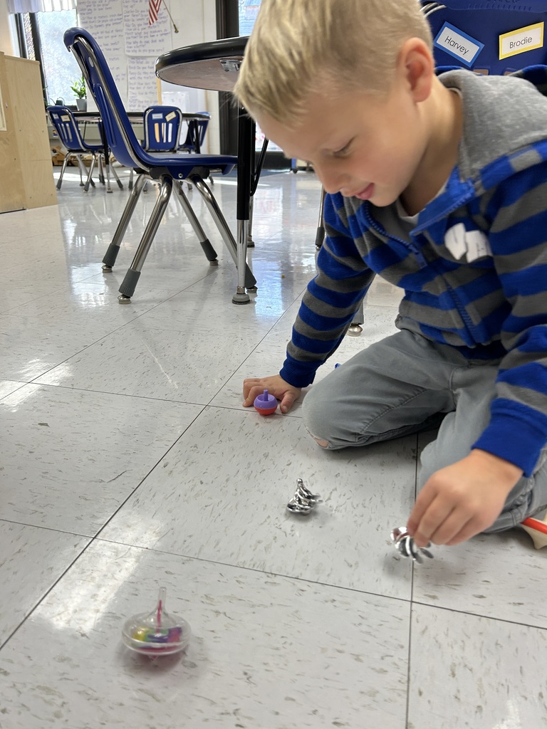 A student playing with multiple spin toys.