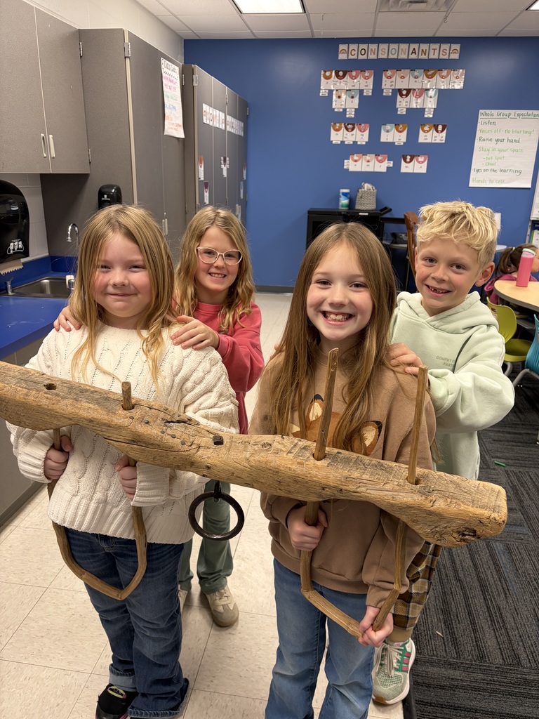 Four students with the oxen wood piece