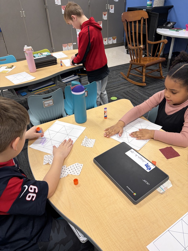 Students designing their quilt pieces on paper