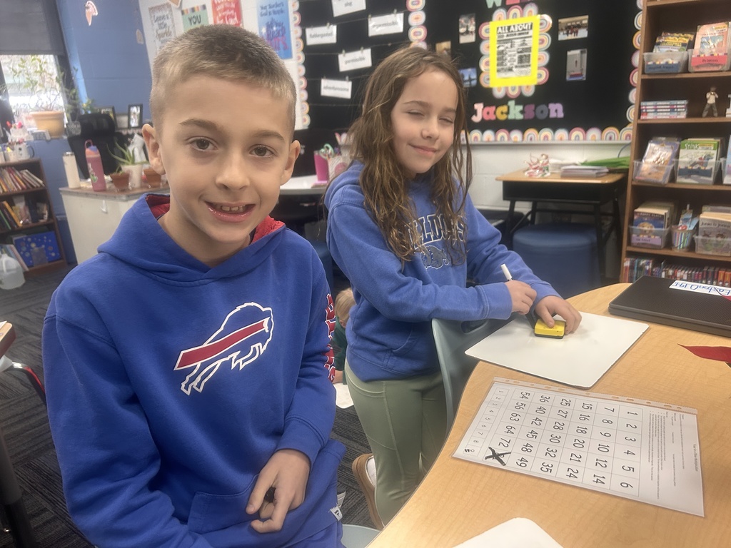 Two students with their whiteboards and activities