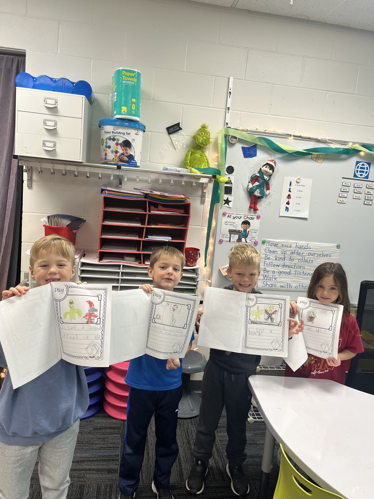 Students showing off their Elf Adventures journals.