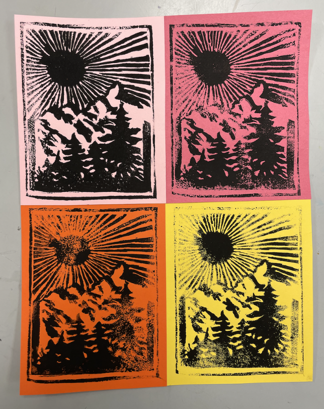 Four colorful prints of a mountain landscape with pine trees and a radiant sun, each in different bright backgrounds: pink, red, orange, and yellow.