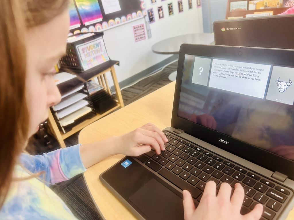 Computer screen of a girl with red hair and tie-dye shirt.