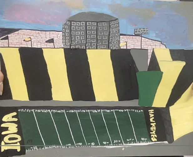 Hand-painted depiction of Kinnick Stadium with Iowa Hawkeyes football field and black and yellow striped stands under a cloudy sky.