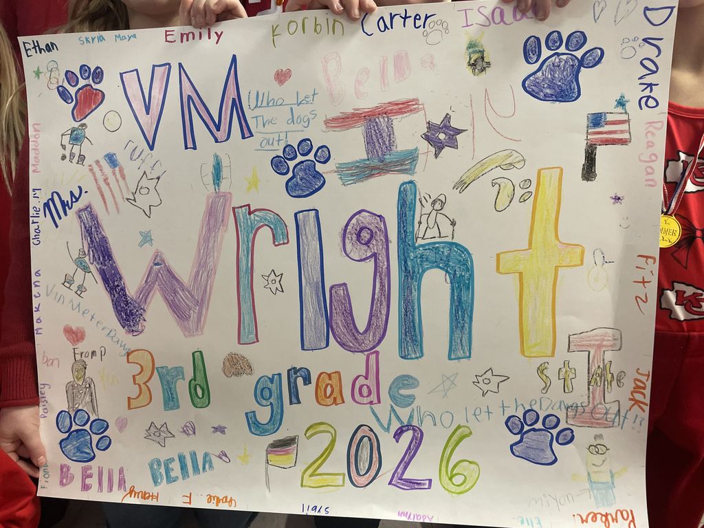Colorful handmade poster with 'Wright 3rd grade - 2026' surrounded by paw prints, stars, and student names in various colors.