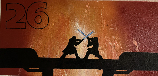 Silhouettes of two figures engaged in a lightsaber duel against a textured orange background with the number 26 in the corner.