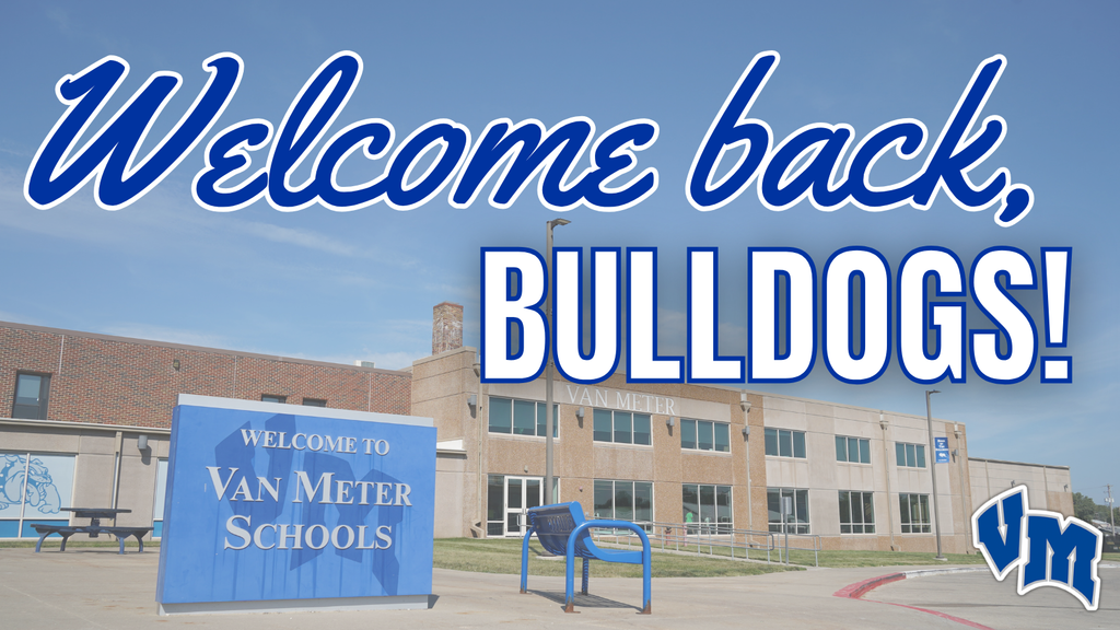 Blue sign reading 'Welcome to Van Meter Schools' in front of a brick school building under a clear sky.