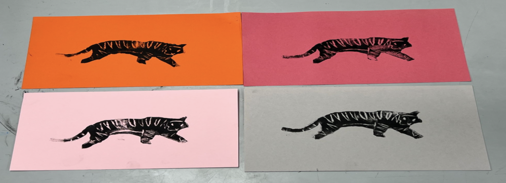 Four rectangular cards each featuring a black tiger silhouette on different colored backgrounds: orange, pink, light pink, and gray.