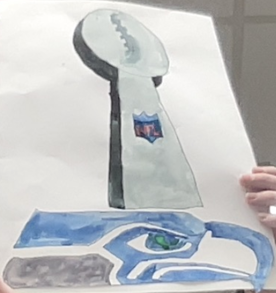 Drawing of a football trophy above a stylized bird head logo, held up by hands against a plain background.