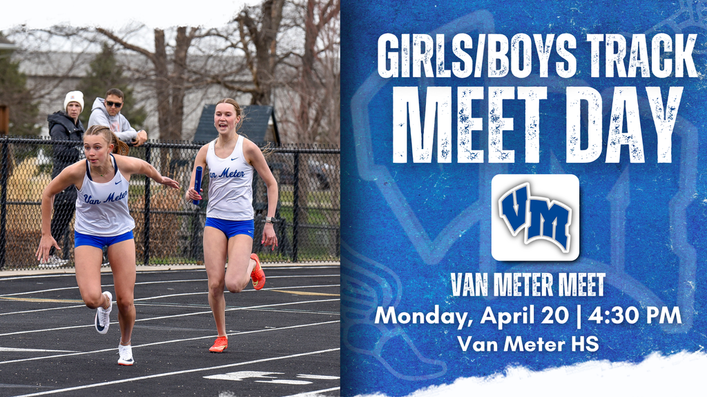 Two female runners in blue and white uniforms sprinting on a track during a relay race at Van Meter Meet Day.