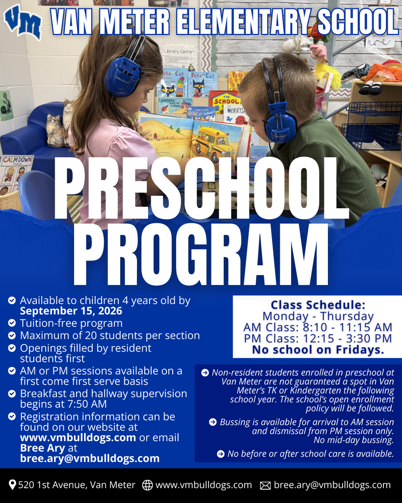 Two preschool children wearing headphones read a colorful book together in a classroom filled with educational materials at Van Meter Elementary School.